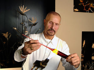 Hans Godo Frabel sculpting glass under a torch at Frabel Studio